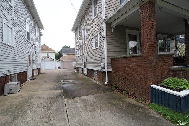 633 Scott St, Monroe, MI 48161 - view of side of property featuring an outdoor structure and a garage