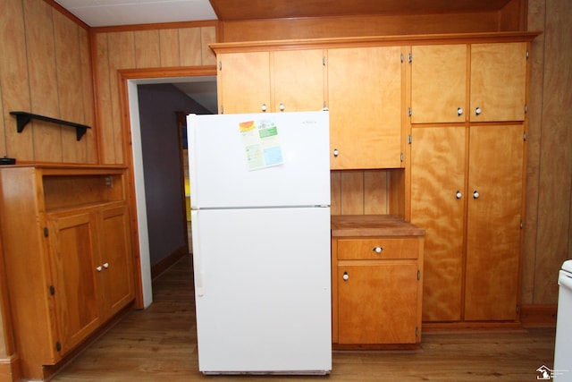 633 Scott St, Monroe, MI 48161 - kitchen with freestanding refrigerator, light wood-type flooring, wood walls, and light countertops