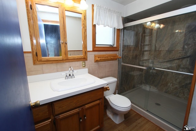 633 Scott St, Monroe, MI 48161 - bathroom with toilet, vanity, a stall shower, tile walls, and wood finished floors