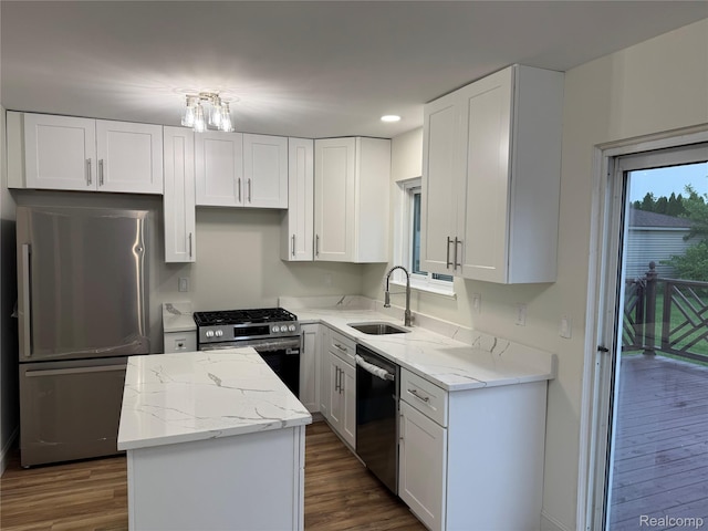 42113 Clayton St, Clinton Township, MI 48038 - kitchen featuring appliances with stainless steel finishes, a sink, a kitchen island, light stone counters, and recessed lighting