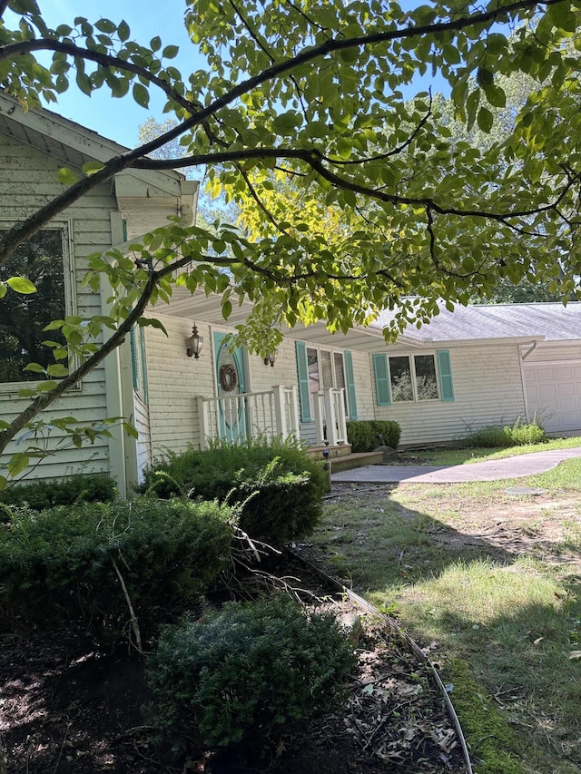 9679 Almena Dr, Kalamazoo, MI 49009 - view of front of house featuring an attached garage and brick siding