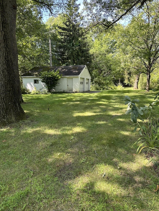 9679 Almena Dr, Kalamazoo, MI 49009 - view of grassy yard with a garage