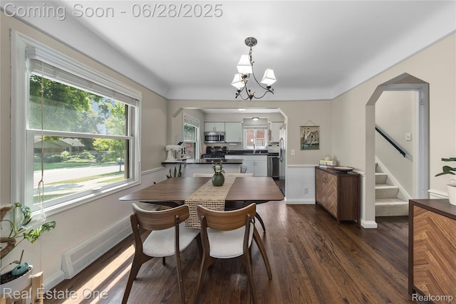 4507 Groveland Ave, Royal Oak, MI 48073 - dining area featuring stairs, a chandelier, dark wood-type flooring, and arched walkways