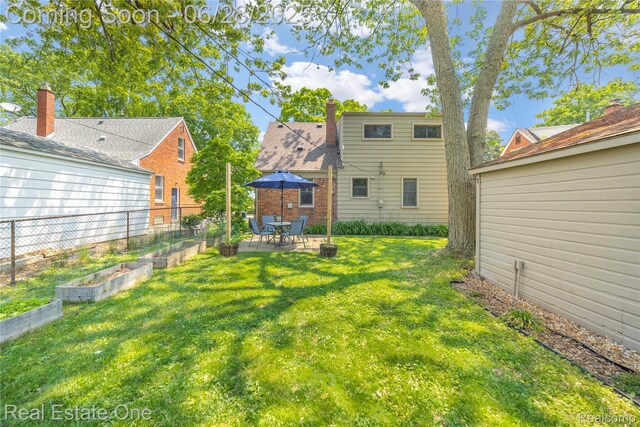4507 Groveland Ave, Royal Oak, MI 48073 - view of grassy yard featuring a garden and a patio