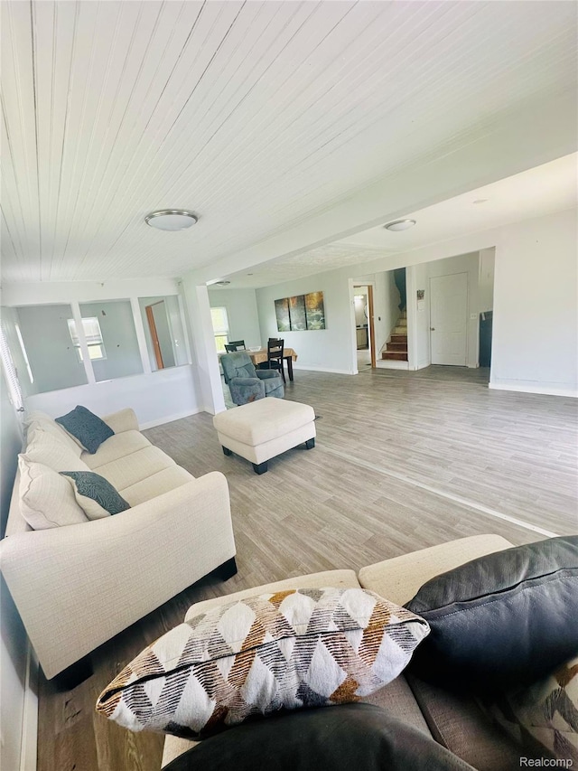 6196 W Plains Rd, Eaton Rapids, MI 48827 - living area with stairway, wood finished floors, baseboards, plenty of natural light, and wood ceiling