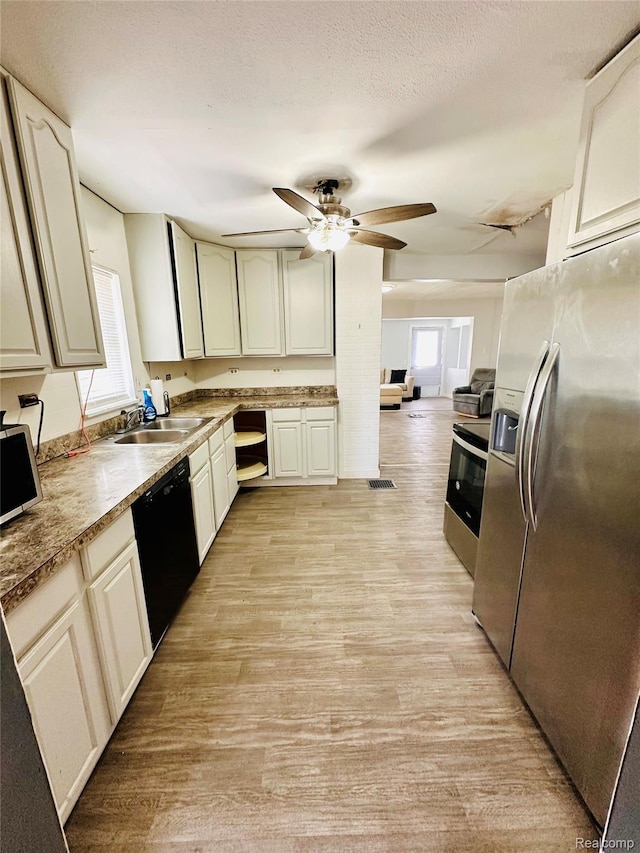 6196 W Plains Rd, Eaton Rapids, MI 48827 - kitchen featuring appliances with stainless steel finishes, a sink, ceiling fan, light wood-style flooring, and a textured ceiling