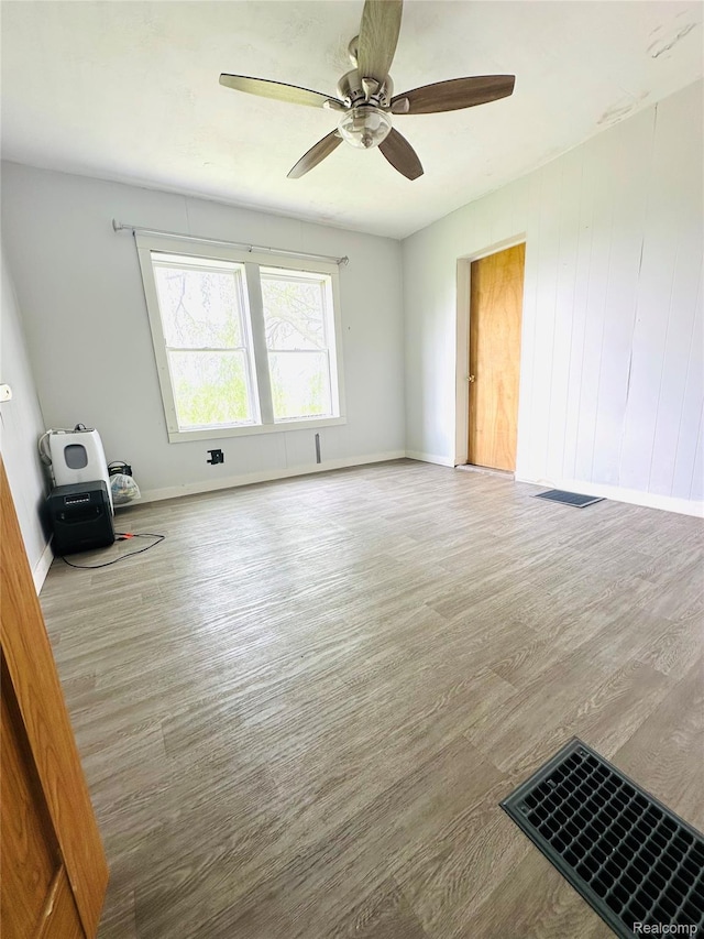 6196 W Plains Rd, Eaton Rapids, MI 48827 - spare room with ceiling fan, wood finished floors, and baseboards