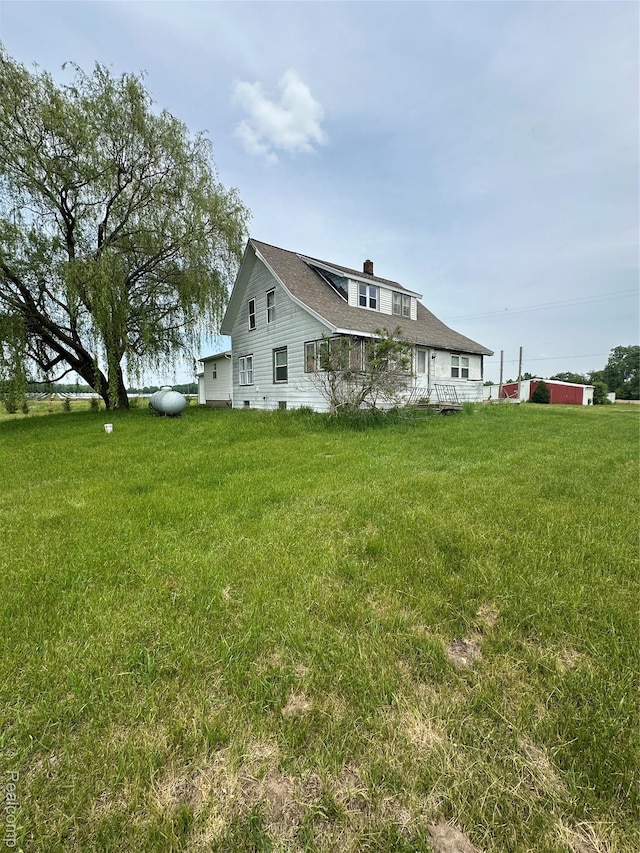 6196 W Plains Rd, Eaton Rapids, MI 48827 - view of home's exterior with a yard and a chimney