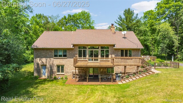 1145 W Moore Rd, Milford, MI 48381 - rear view of house featuring brick siding, a wooden deck, a patio, a yard, and a chimney