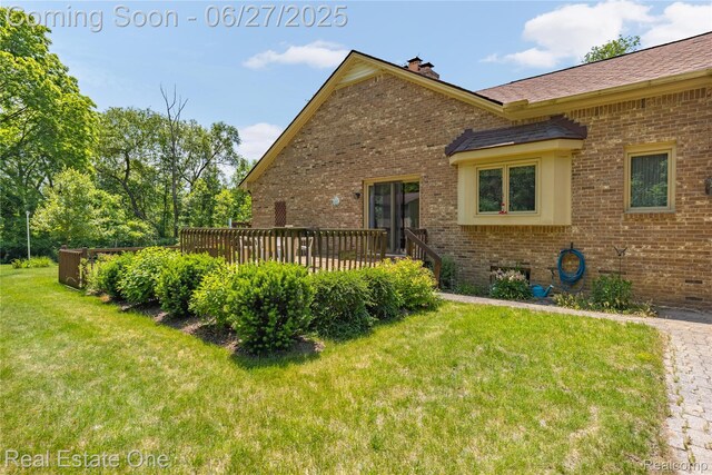 1145 W Moore Rd, Milford, MI 48381 - view of side of property with brick siding, a yard, a wooden deck, and a chimney