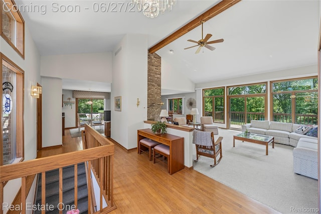 1145 W Moore Rd, Milford, MI 48381 - living room with high vaulted ceiling, beam ceiling, light wood-type flooring, ceiling fan, and a chandelier