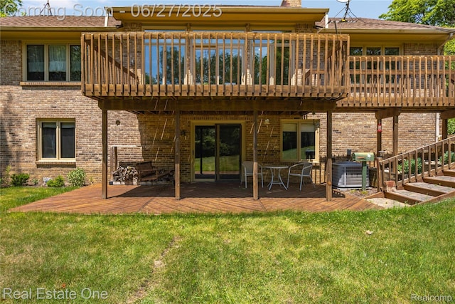 1145 W Moore Rd, Milford, MI 48381 - back of house with a wooden deck, a lawn, and brick siding