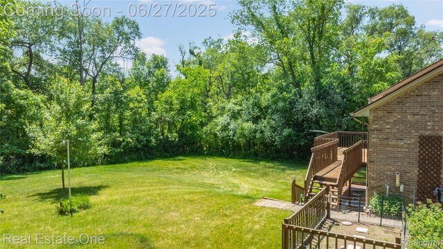 1145 W Moore Rd, Milford, MI 48381 - view of green lawn with a wooden deck and stairway