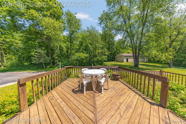 1145 W Moore Rd, Milford, MI 48381 - wooden deck with a lawn and outdoor dining area