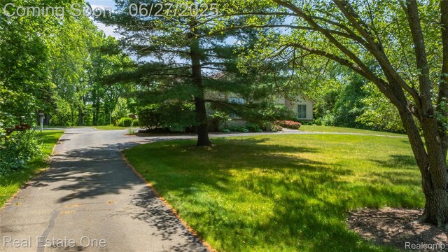 1145 W Moore Rd, Milford, MI 48381 - view of front of property with a front lawn and driveway