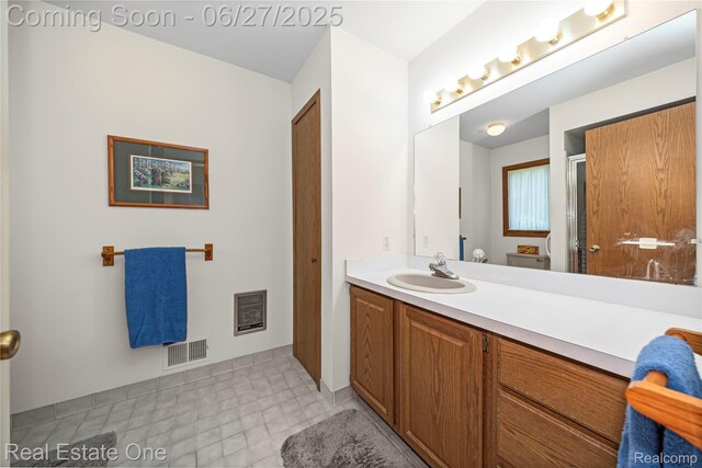 1145 W Moore Rd, Milford, MI 48381 - full bathroom featuring vanity, heating unit, and a shower with door