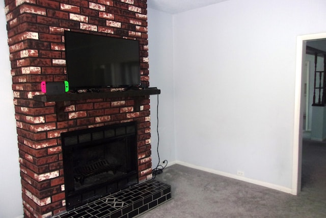 602 Fairview Ave, Manistee, MI 49660 - detailed view of carpet floors, a fireplace with raised hearth, and baseboards
