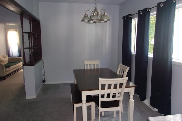 602 Fairview Ave, Manistee, MI 49660 - carpeted dining room featuring a chandelier and baseboards
