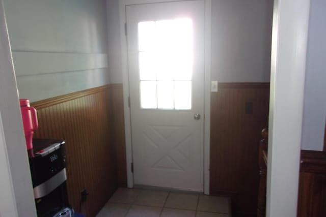 602 Fairview Ave, Manistee, MI 49660 - doorway featuring wainscoting and light tile patterned floors