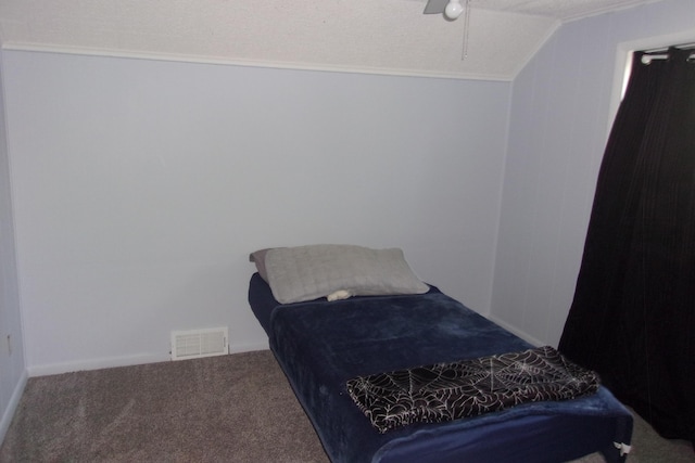 602 Fairview Ave, Manistee, MI 49660 - bedroom featuring carpet flooring, crown molding, vaulted ceiling, and a ceiling fan