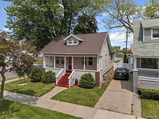809 E Bennett Ave, Ferndale, MI 48220 - bungalow-style home with a porch, concrete driveway, and stairs