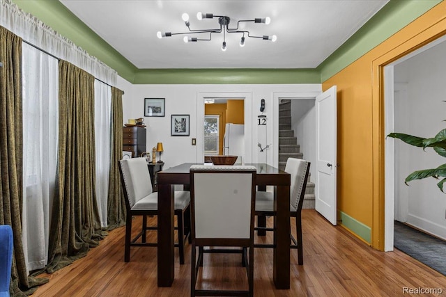 809 E Bennett Ave, Ferndale, MI 48220 - dining room with wood finished floors, stairs, and a chandelier