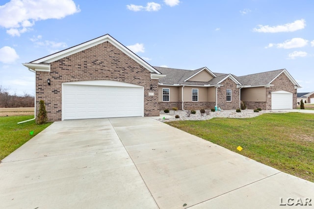 2819 Eunice Cir, Adrian, MI 49221 - view of front of property featuring brick siding, a garage, and a front lawn