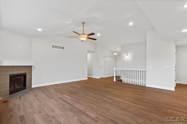 2819 Eunice Cir, Adrian, MI 49221 - unfurnished living room with ceiling fan, lofted ceiling, wood finished floors, baseboards, and a fireplace