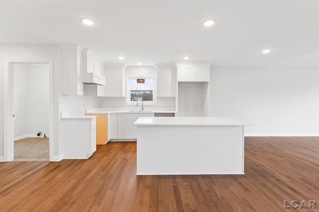 2819 Eunice Cir, Adrian, MI 49221 - kitchen with a sink, a center island, white cabinets, baseboards, and recessed lighting