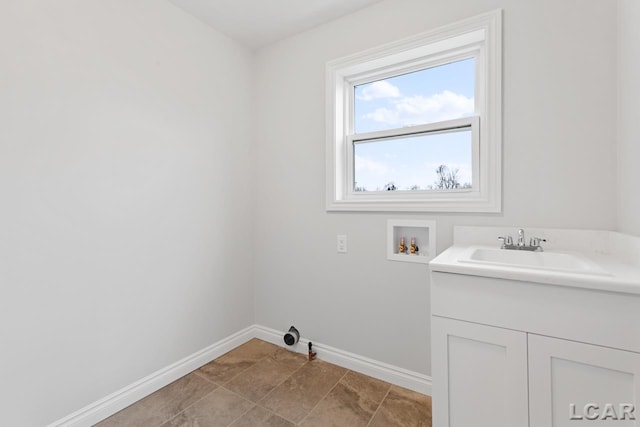 2819 Eunice Cir, Adrian, MI 49221 - washroom featuring washer hookup, baseboards, and cabinet space