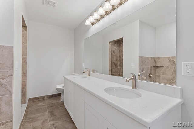 2819 Eunice Cir, Adrian, MI 49221 - bathroom with double vanity and toilet