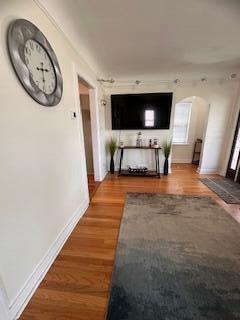 26314 E St, Saint Clair Shores, MI 48081 - hallway with arched walkways, baseboards, and wood finished floors