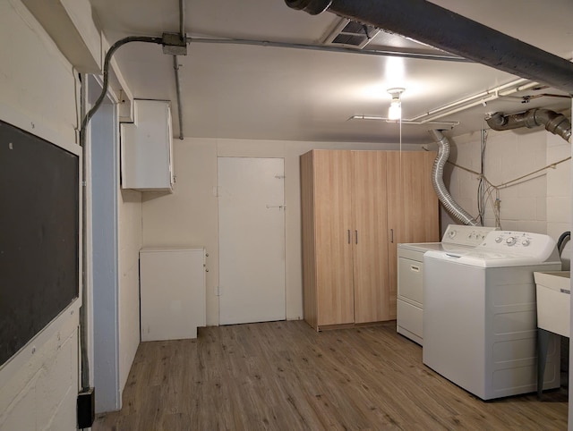 26314 E St, Saint Clair Shores, MI 48081 - washroom featuring separate washer and dryer, light wood finished floors, and concrete block wall