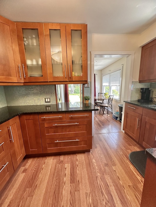 26314 E St, Saint Clair Shores, MI 48081 - kitchen featuring light wood-style floors, brown cabinetry, and decorative backsplash