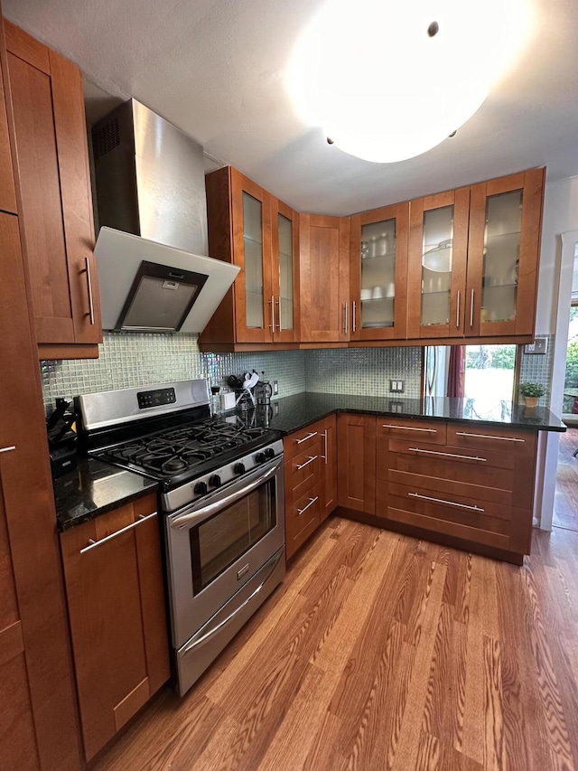 26314 E St, Saint Clair Shores, MI 48081 - kitchen featuring stainless steel gas stove, wall chimney range hood, light wood finished floors, and brown cabinets