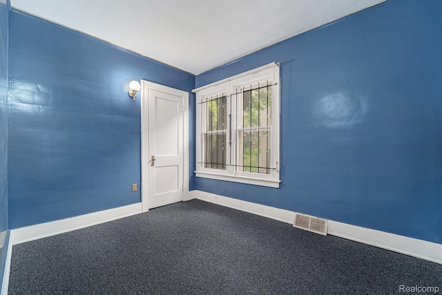 74 W Dakota, Highland Park, MI 48203 - empty room featuring baseboards and dark colored carpet