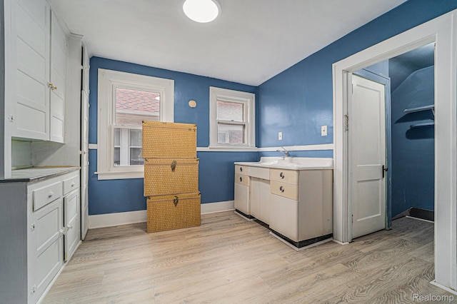 74 W Dakota, Highland Park, MI 48203 - kitchen featuring light wood-type flooring, white cabinets, baseboards, and light countertops