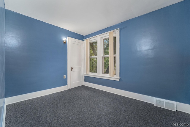 74 W Dakota, Highland Park, MI 48203 - spare room featuring dark colored carpet and baseboards