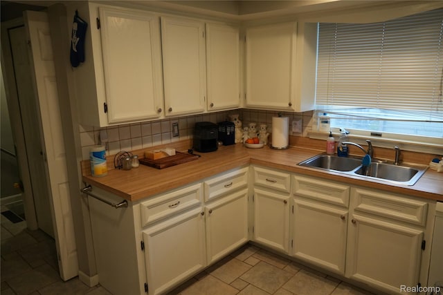 106 S Marias Ave, Clawson, MI 48017 - kitchen featuring backsplash, white cabinets, and light countertops