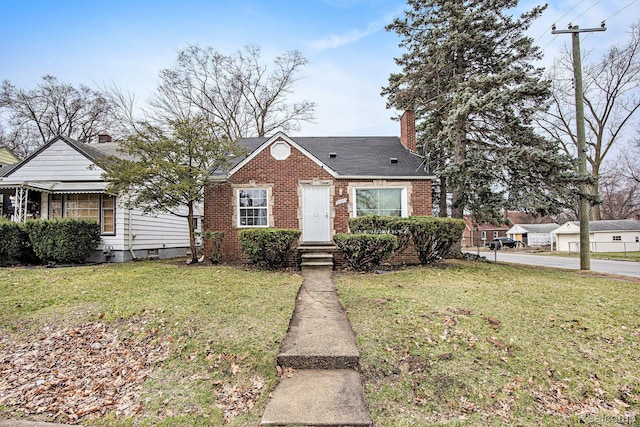 20265 Yonka St, Detroit, MI 48234 - bungalow-style house with brick siding, a front lawn, and a chimney