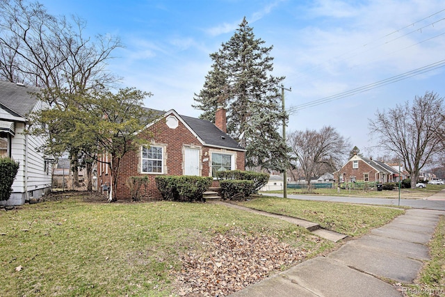 20265 Yonka St, Detroit, MI 48234 - view of side of property featuring brick siding, a yard, and a chimney