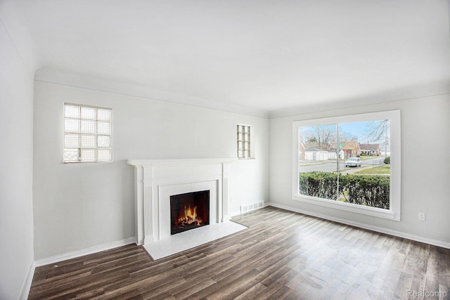 20265 Yonka St, Detroit, MI 48234 - unfurnished living room featuring wood finished floors, a fireplace with flush hearth, and baseboards