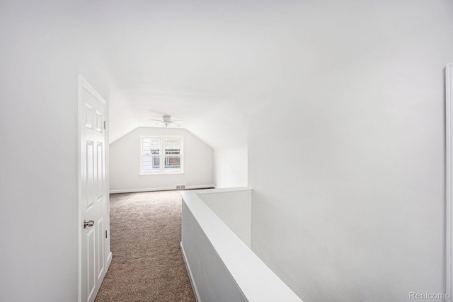 20265 Yonka St, Detroit, MI 48234 - corridor featuring an upstairs landing, dark carpet, lofted ceiling, and baseboards