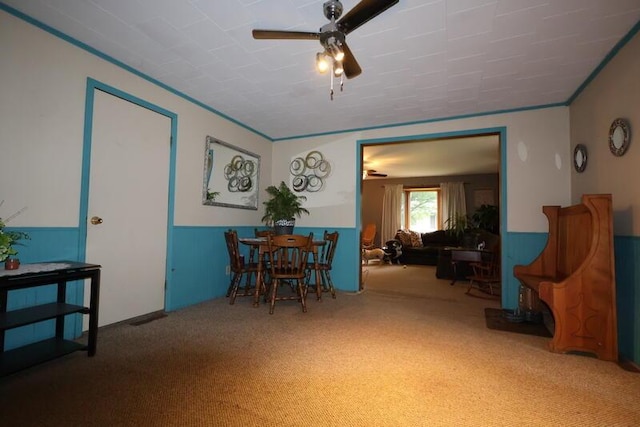 113 S Park St, Union City, MI 49094 - carpeted dining space featuring a wainscoted wall and ceiling fan
