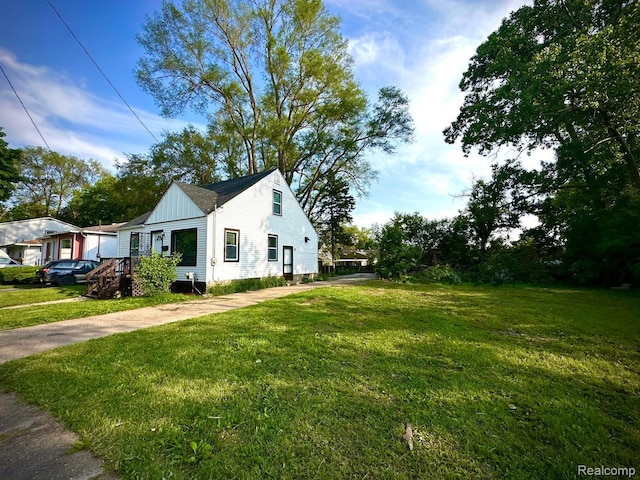 2825 Raskob St, Flint, MI 48504 - view of home's exterior with a yard and board and batten siding