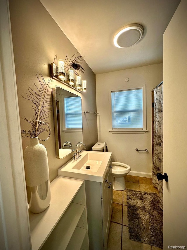 2825 Raskob St, Flint, MI 48504 - bathroom with vanity, toilet, tile patterned floors, and plenty of natural light