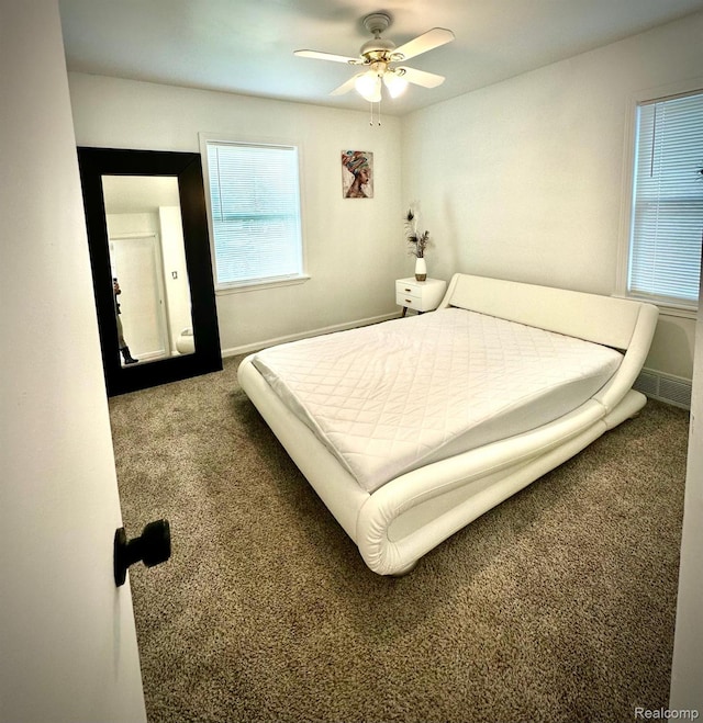 2825 Raskob St, Flint, MI 48504 - carpeted bedroom with multiple windows, baseboards, and ceiling fan