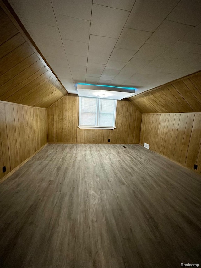 2825 Raskob St, Flint, MI 48504 - additional living space with wooden walls, wood finished floors, and lofted ceiling
