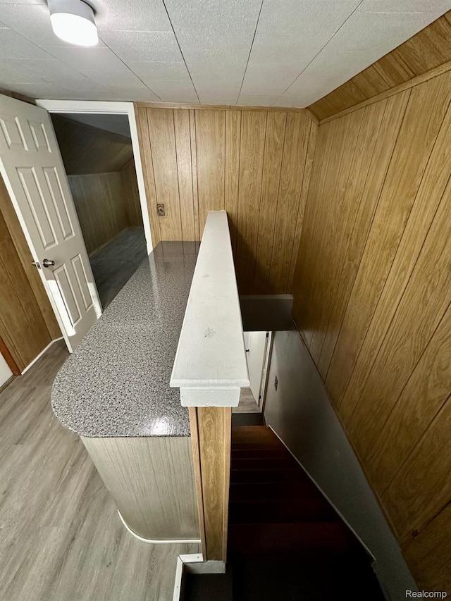 2825 Raskob St, Flint, MI 48504 - staircase featuring wooden walls and wood finished floors