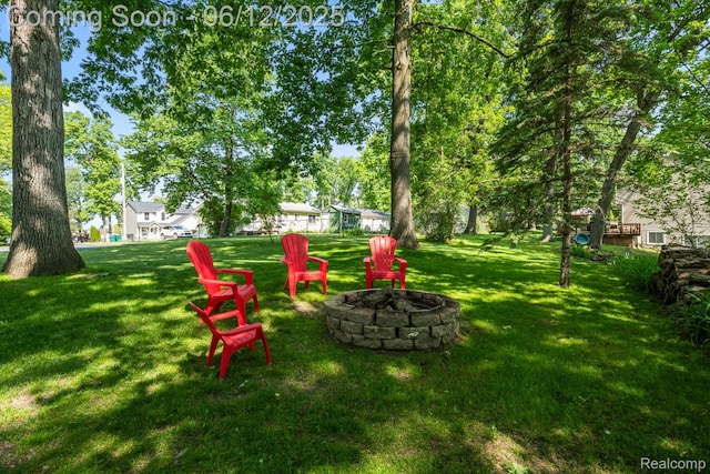 6287 Woodring Ct, Brighton, MI 48116 - view of green lawn featuring an outdoor fire pit